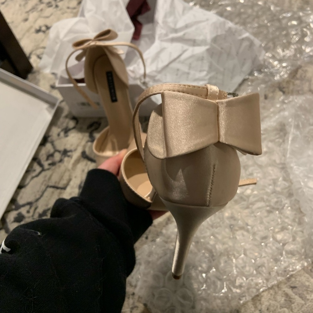 Size 6 champagne color heels with bow on the back and ankle strap